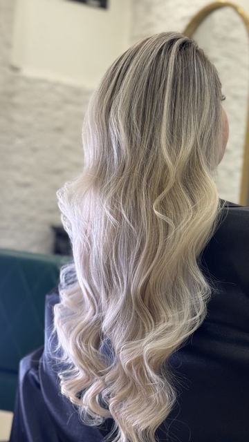 بالیاژ از قهوه‌ای خاکستری تیره به بلوند پلاتینی روی موی خیلی بلند با موج‌های درشت